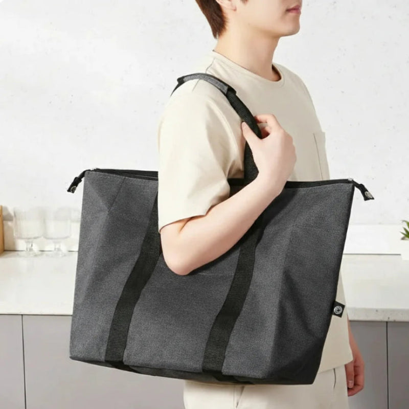 Grand sac isotherme noir porter par une personne autour de l'épaule