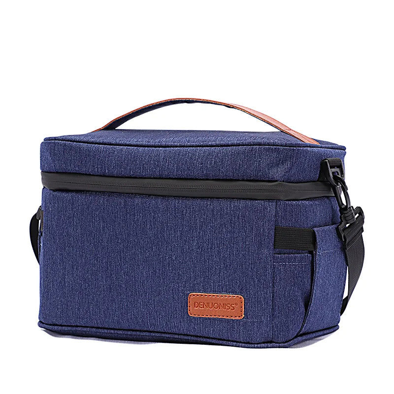 Lunch bag isotherme 7L bleu denim vu en angle, avec poignée renforcée et poches latérales, conçu pour transporter un repas frais au quotidien.