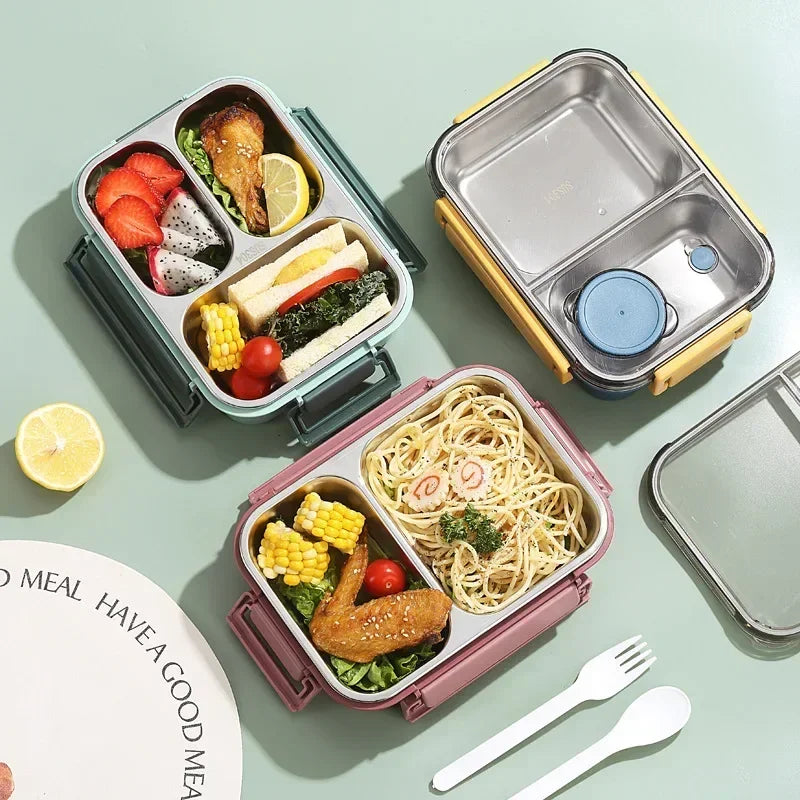 Lunch box isotherme en acier inoxydable avec plusieurs compartiments, idéale pour transporter un repas équilibré composé de pâtes, légumes, fruits et sandwich.