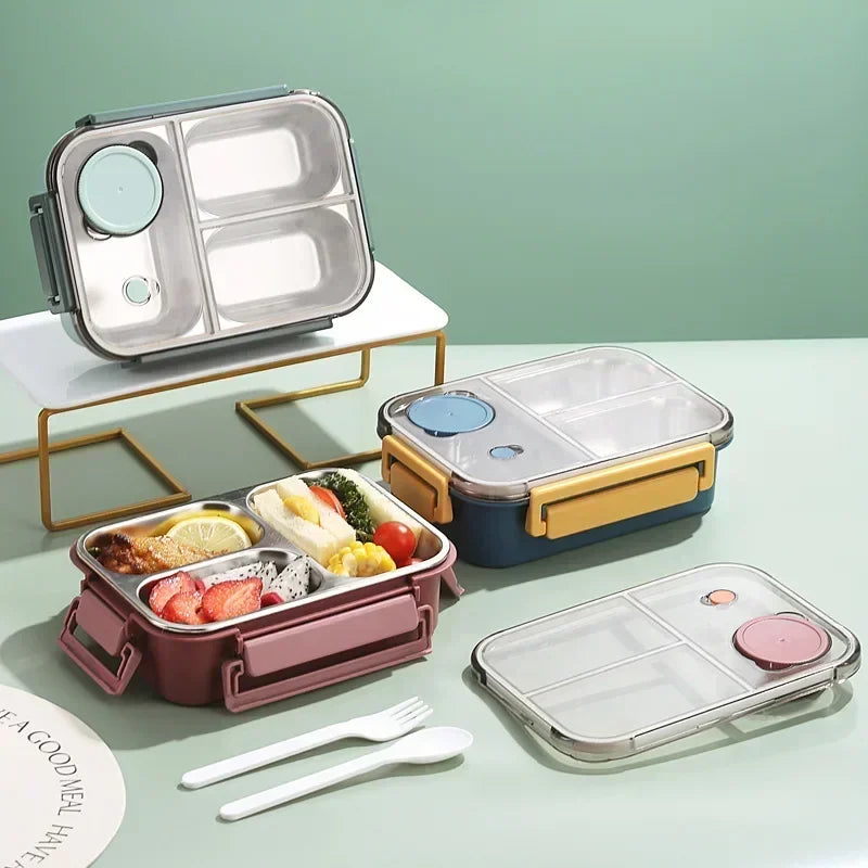 Lunch box isotherme en inox à trois compartiments, disponible en plusieurs couleurs (rose, bleu, jaune), avec couvercle hermétique et couverts inclus, idéale pour emporter un repas complet au bureau ou à l’école.
