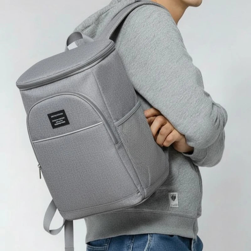 sac à dos isotherme gris porté à l’épaule par un homme, vue de profil