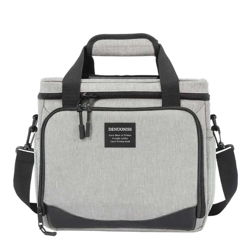 Sac isotherme gris 13l vu de face, avec poignée rembourrée, poche frontale zippée et bandoulière réglable.