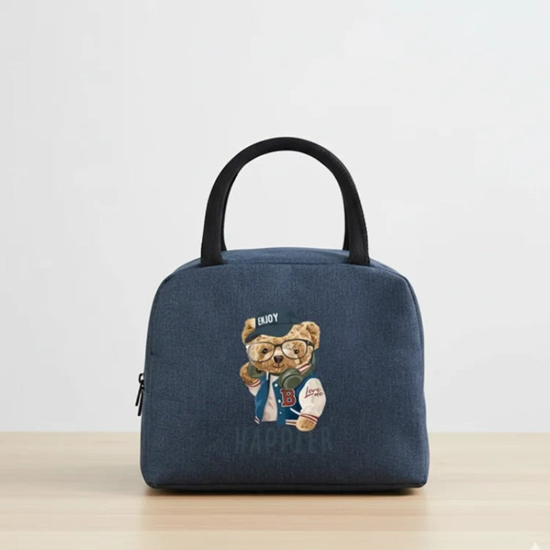 Sac isotherme repas bleu marine, vue de face. Motif ours de couleur marron, poser sur une table.