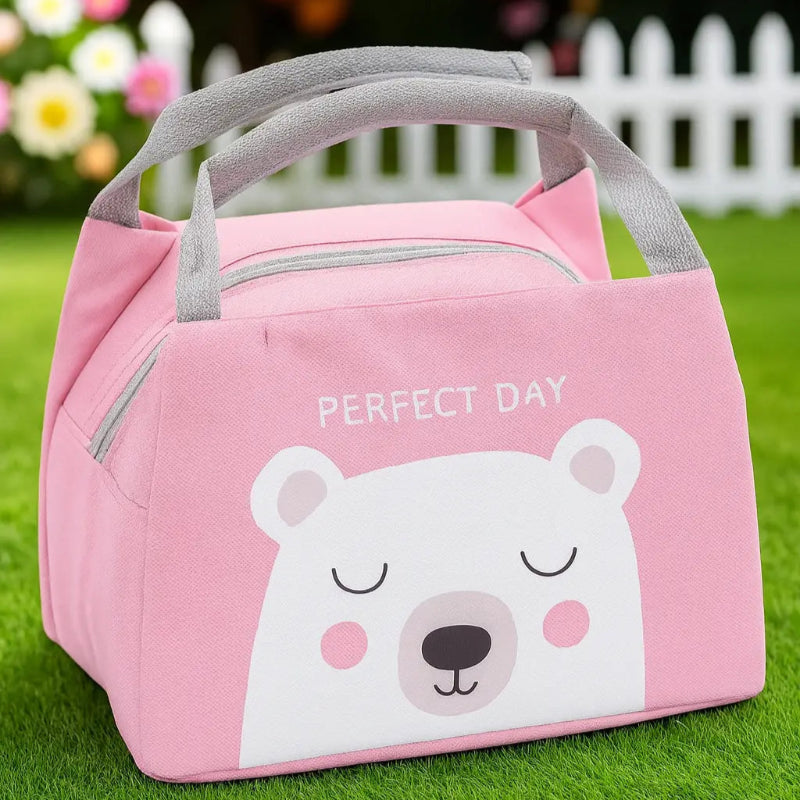 Sac isotherme bebe rose avec motif ours blanc dans un jardin