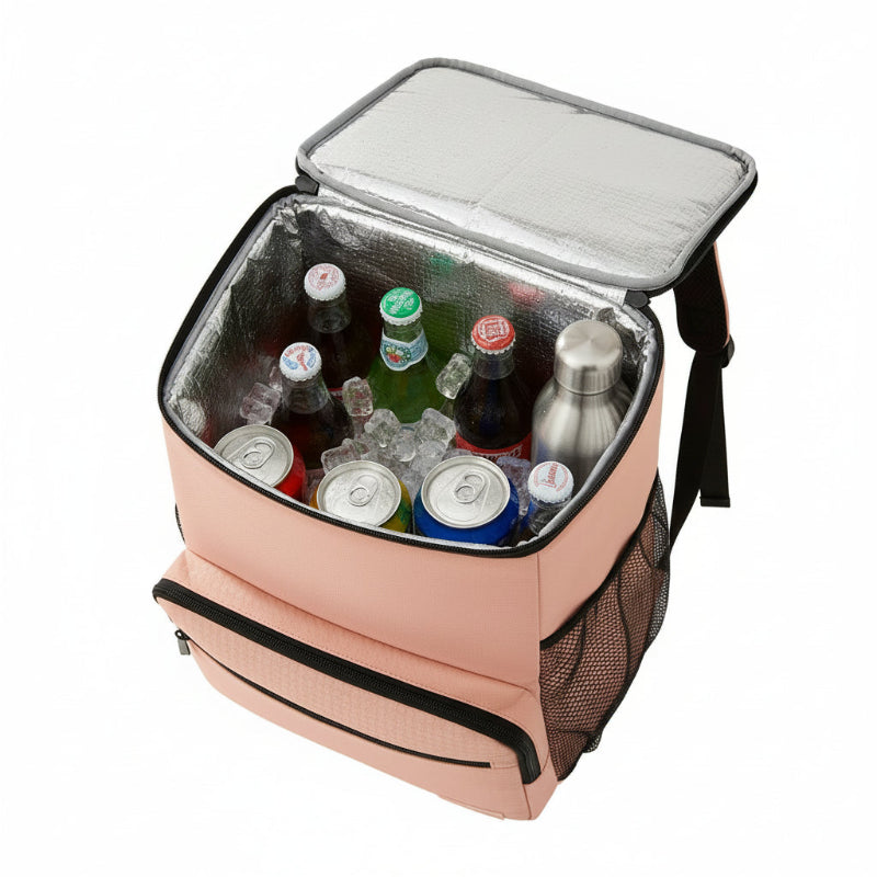 Sac à dos isotherme rose ouvert, montrant l’intérieur aluminium rempli de boissons et de glaçons, conçu pour garder le froid lors des sorties.