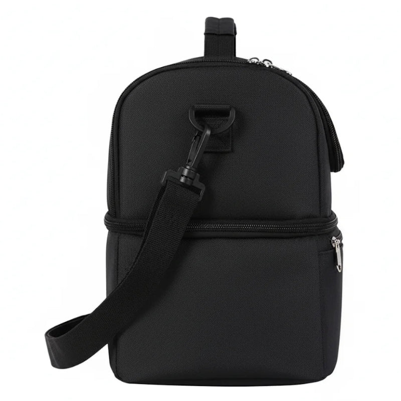 Vue de côté d’un sac isotherme noir à double compartiment, avec bretelle détachable fixée sur le côté.